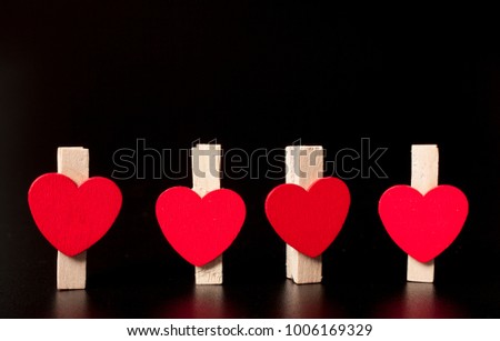 heart clothespins on dark background