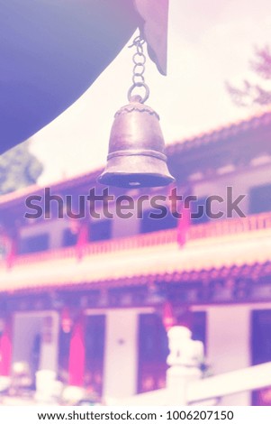 Color toned picture of a temple bell, selective focus, China.