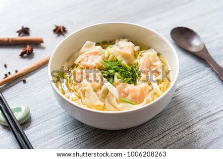 Shrimp wonton with braised pork in soup on wooden table - Asian food style, Select focus image Royalty-Free Stock Photo #1006208263