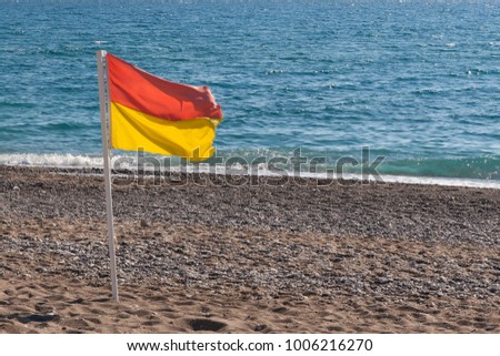 surf conditions, yellow red flag on the beach