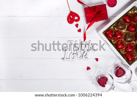 Delicious chocolate candies in gift box with gift box on a white wooden background. Greeting card for Mother's Day, 8 March, Birthday, Valentines Day copy space flat lay
