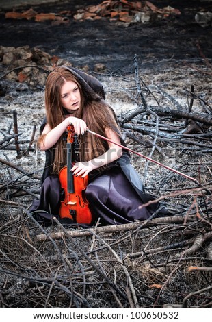 The red-haired girl with a violin sitting on the ashes