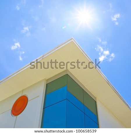 beautiful building corner on a background of the blue sky and in solar patches of light