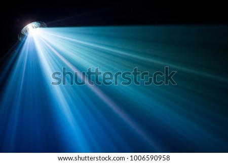 projector beautiful lighting . wide lens equipment for show presentation at night . smoke abstract background . Royalty-Free Stock Photo #1006590958