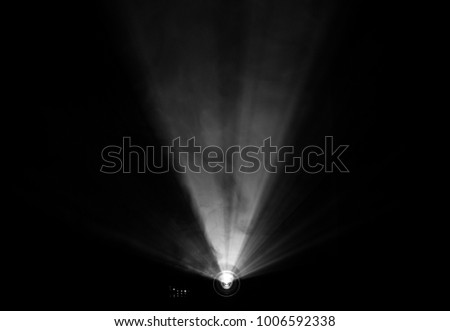 projector beautiful lighting . wide lens equipment for show presentation at night . smoke abstract background . Royalty-Free Stock Photo #1006592338