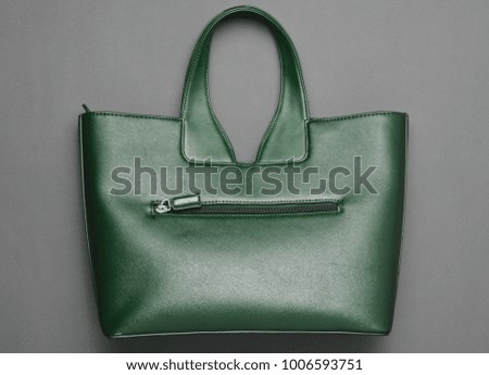 Fashionable leather bag on a gray paper background. Top view.