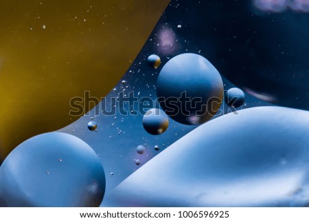 mixing water and oil, beautiful color abstract background based on blue and orange circles and ovals, macro abstraction