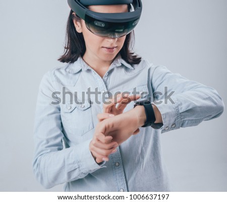 Woman wearing augmented reality goggles. White background in studio