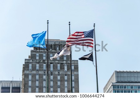 Boston, MA USA - american flag waving with skyscrapers in the background skyline
