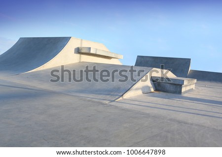 outdoor skatepark with blue sky and grey concerete in harwich, essex, uk