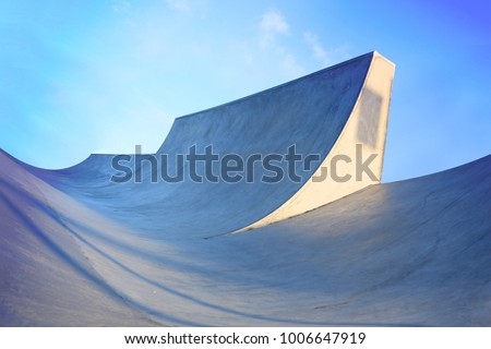 outdoor skatepark with blue sky and grey concrete in harwich, essex, uk Royalty-Free Stock Photo #1006647919