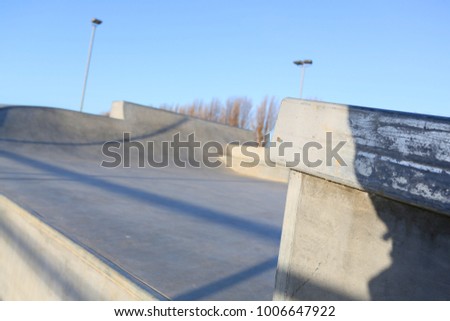 outdoor skatepark with blue sky and grey concrete in harwich, essex, uk