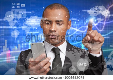 Self confident mixed race male in formal wear uses futuristic touchscreen display and modern mobile phone, draws diagrams. Technology, people, development. Double exposure and visual effects