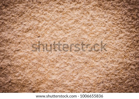 Rock, stone texture, background, surface. Brown wall architecture material. Wallpaper with abstract texture. Old rough granite structure. Natural vintage construction.