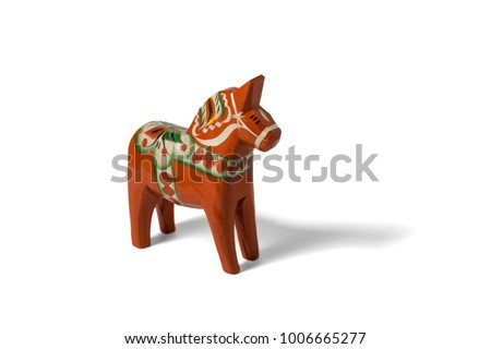 Dala horse isolated on white background. The dala horse is a traditional carved, painted wooden statue of a horse made in the provinces Dalarna in Sweden.