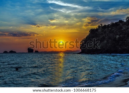 Beautiful tropical sunset on the stone beach
