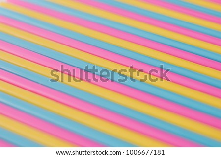 Background of colorful cocktail straws saturated pastel colors.