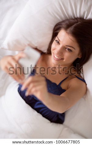 
Pretty brunette girl like taking selfie in bed in the morning