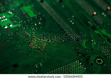 Close up macro of electronic chip in green and black colors . Background texture with copy space . Computer elements, abstract motherboard . Connection, technology  and internet concept
