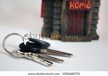keys from the house with a small house on a white background. real estate concept. The concept of the house turnkey.