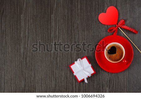 Valentines day background. Red hearts and cup of coffee on wooden background. Flat lay composition.Valentine concept