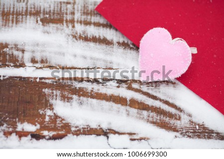 Beautiful romantic vintage red heart on a white snow winter background. Love and St. Valentines Day concept.