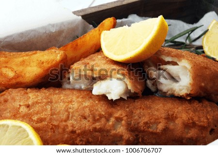 traditional British fish and chips with potato and lemon