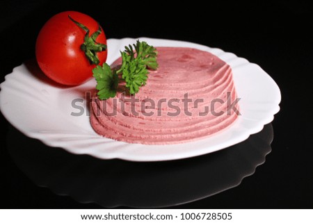Round ham. Sliced pink ham meat on black reflective studio background. Isolated black shiny mirror mirrored background for every concept.