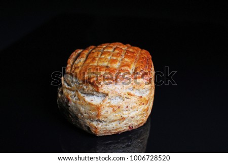 Scone. Pastry round scone on black reflective studio background. Isolated black shiny mirror mirrored background for every concept.