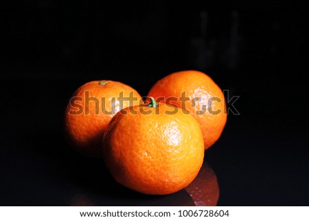 Mandarins. Mandarin citrus orange fruit mandarins on black reflective studio background. Isolated black shiny mirror mirrored background for every concept.