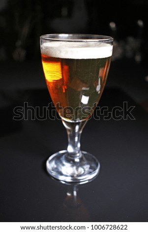 Beer. Light yellow golden beer with glass on black reflective studio background. Isolated black shiny mirror mirrored background for every concept.