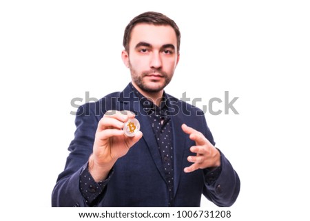 Handsome business man in suit with bitcoin in hand isolated on white
