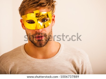 businessman in the venetian gold mask with big nose is standing in serious pose