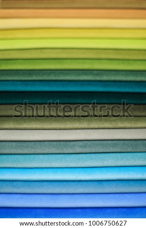 Textile samples. Textile samples for curtains. Yellow, blue, orange, green tone curtain samples hanging. Choice of fabric for home interior.