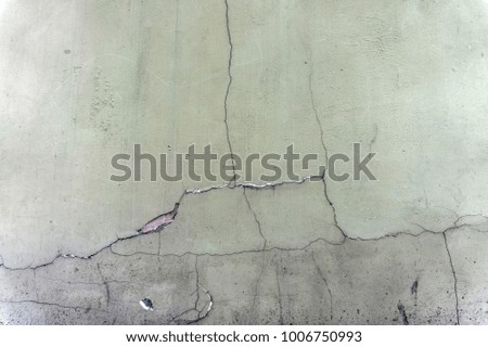 old cracked gray wall. vintage light grey background