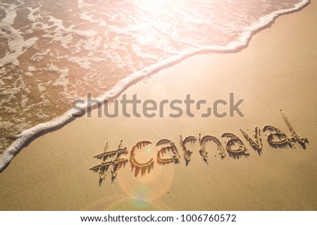 Modern message for Carnaval with a social media-friendly hashtag written on smooth sand beach