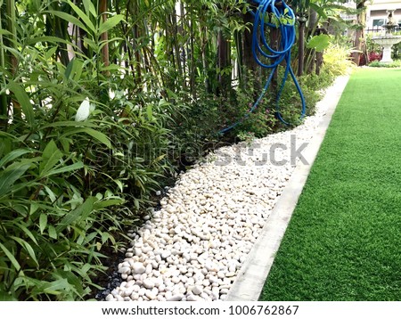 Walkway in the garden by artificial grass , architecture design of grass field around home, artificial grass, home outdoor decoration concept Royalty-Free Stock Photo #1006762867
