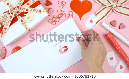 Happy Valentine's Day overhead flat lay wrapping gift and writing cards. 