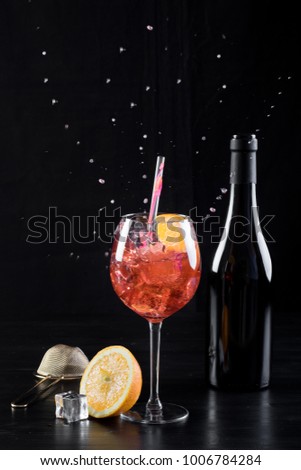 orange spritzer cocktail fancy clean beverage alcohol drink lime mixed bartender black background bottle