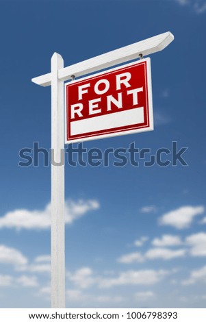 Right Facing For Rent Real Estate Sign on a Blue Sky with Clouds.