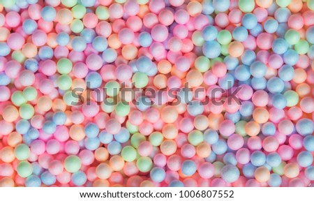 Abstract background from colorful small foam balls patter in box. Happy holiday and travel background concept. Picture for add text message. Backdrop for design art work.