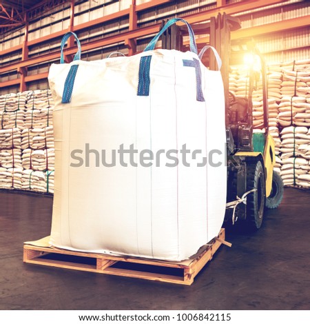 Forklift handling jumbo sugar bag for stuffing into container for export. Distribution, Logistics Import Export, Warehouse operation, Trading, Shipment, Delivery concept. Royalty-Free Stock Photo #1006842115