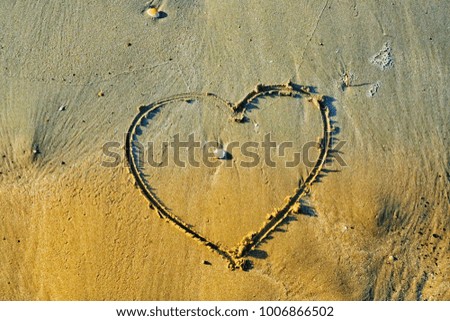 Valentine background . Heart in the sand on the beach in Thailand.