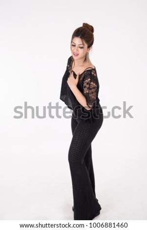 Young pretty girl in black dress posing on white background