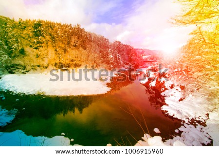 Snow landscape mountains trees and river for natural background.