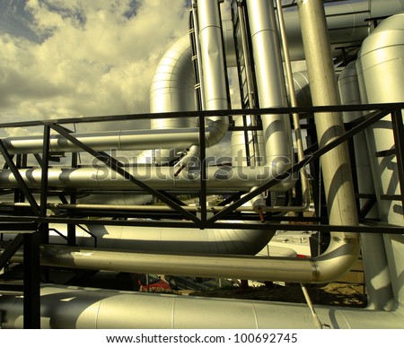 Industrial zone, Steel pipelines and valves against blue sky