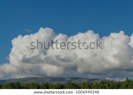 beautiful white Cumulus clouds over the mountains on blue sky background