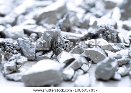 lump of silver or platinum on a stone floor Royalty-Free Stock Photo #1006957837