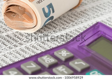 A spreadsheet and euro bills