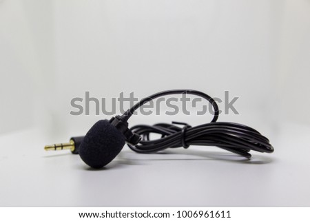Lavalier condenser microphone on white background.